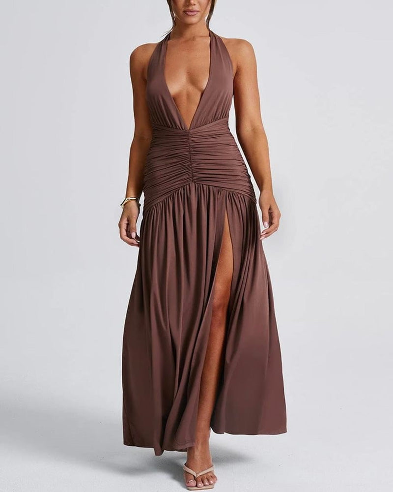 White holiday dress with deep V-neck, open back, ruched detailing, and thigh slit, halter style