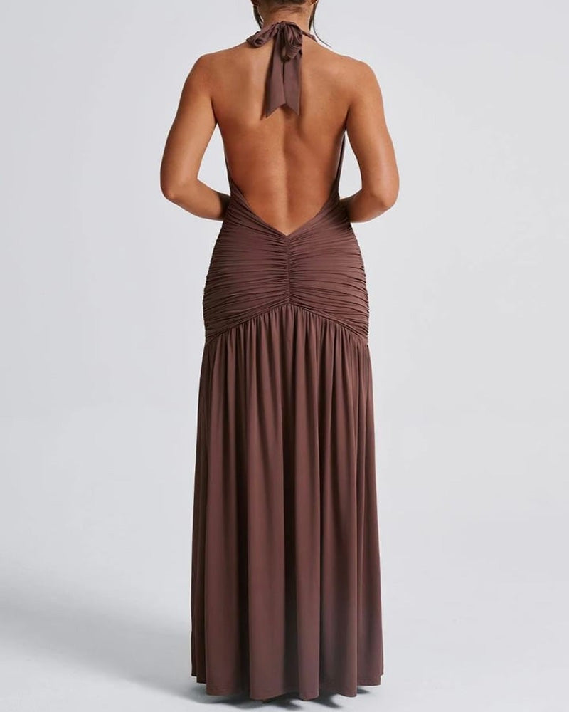 White holiday dress with deep V-neck, open back, ruched detailing, and thigh slit, halter style