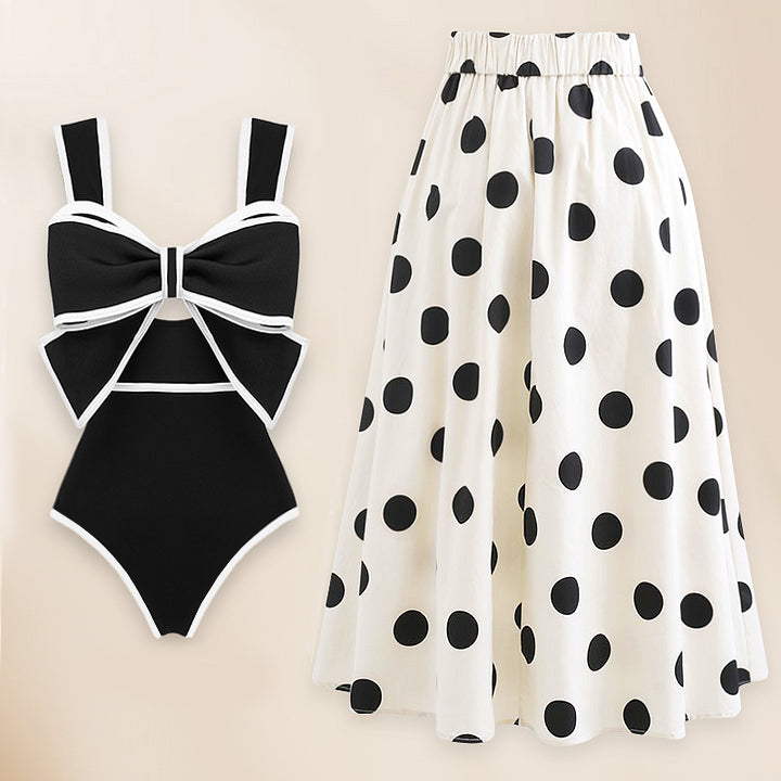 One-piece swimsuit and skirt with black and white bow decoration
