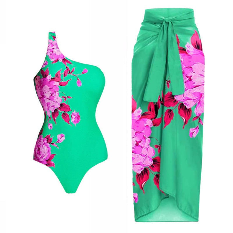 A one-sleeve floral print swimsuit with a sarong