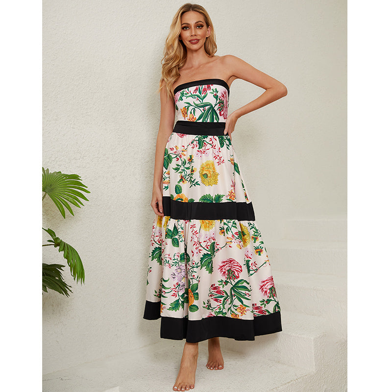 One-piece swimsuit with dropped shoulder straps, tie back, color block print and skirt