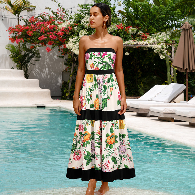 One-piece swimsuit with dropped shoulder straps, tie back, color block print and skirt