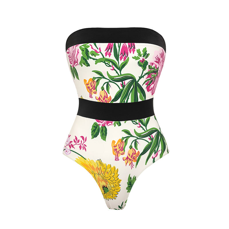 One-piece swimsuit with dropped shoulder straps, tie back, color block print and skirt