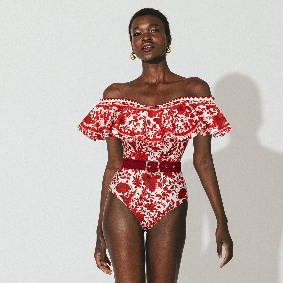 Red flower silhouette print one-piece swimsuit with ruffles and skirt