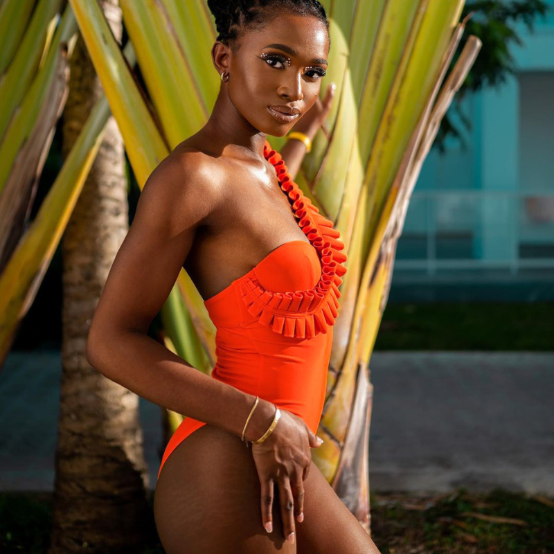 An orange one-sleeve ruffled swimsuit with a sarong