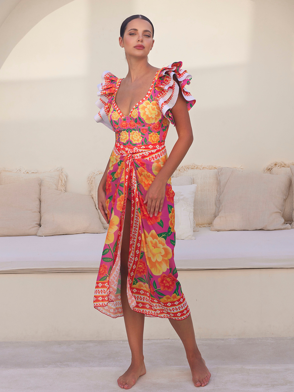 One-piece swimsuit with contrast print and ruffled sarong