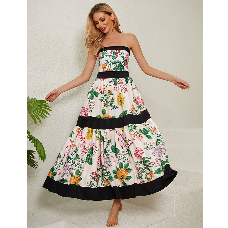 One-piece swimsuit with dropped shoulder straps, tie back, color block print and skirt