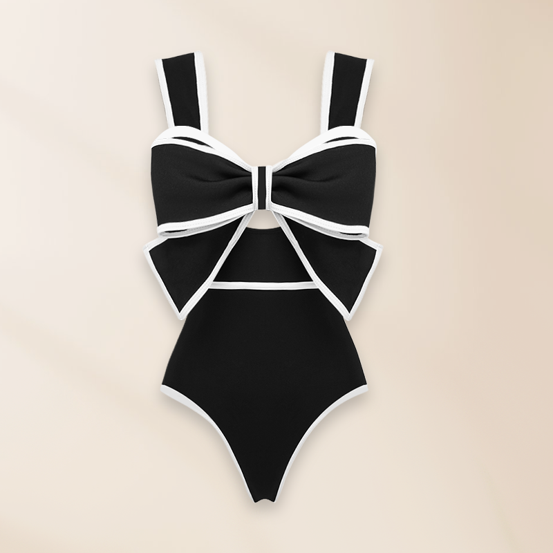 One-piece swimsuit and skirt with black and white bow decoration
