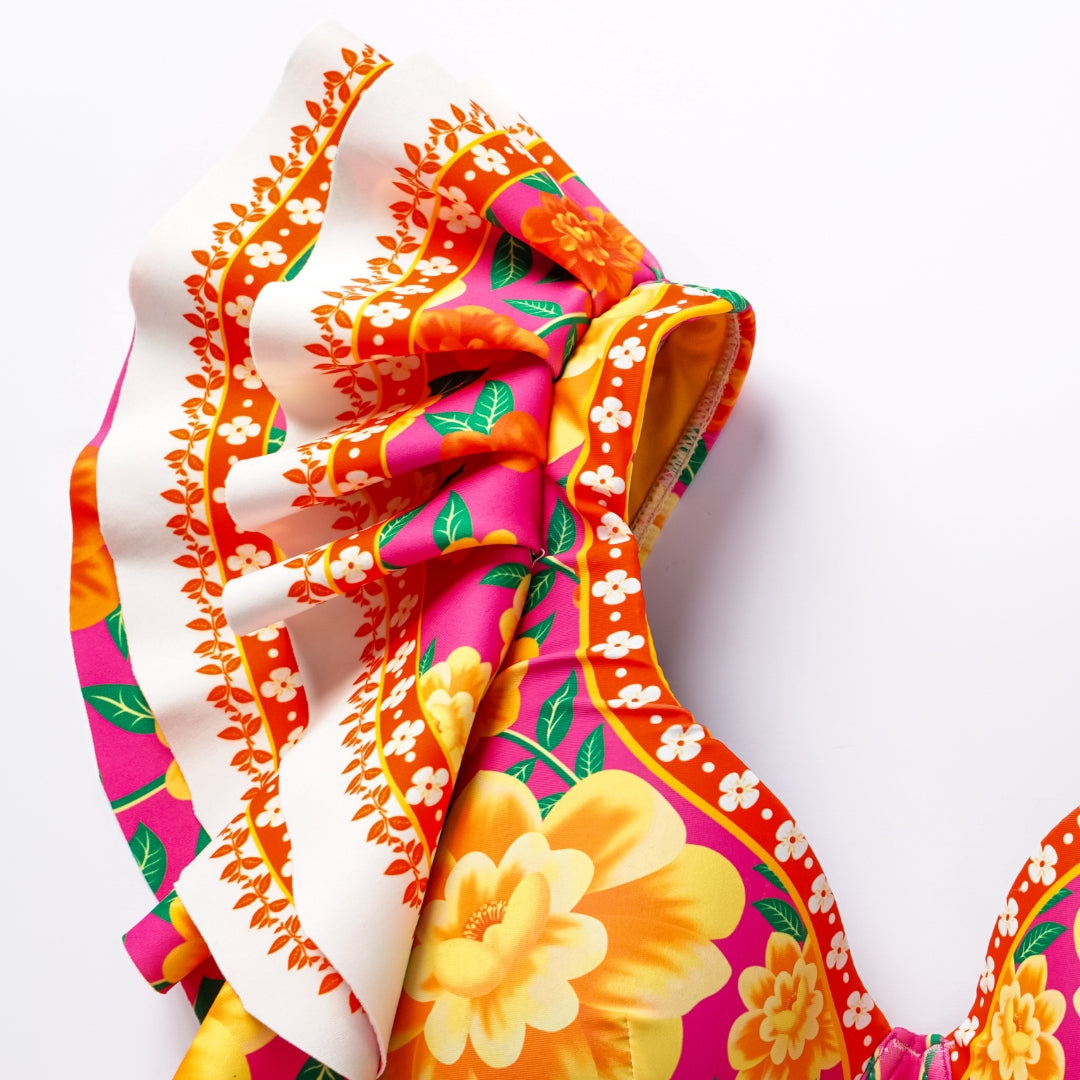 One-piece swimsuit with contrast print and ruffled sarong